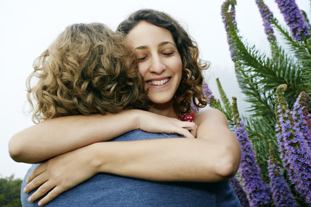 Smiling couple hugging outdoorsの写真素材
