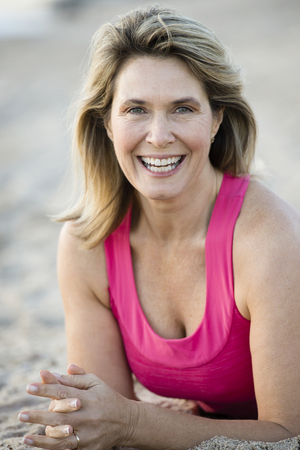 Caucasian woman smiling on beachの写真素材
