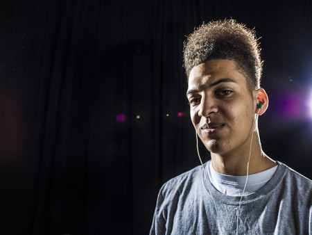 Mixed race man wearing earphonesの写真素材