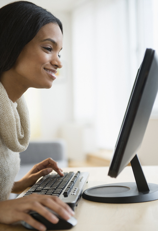 Mixed race woman using computerの写真素材