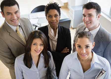 Business people smiling together in officeの写真素材