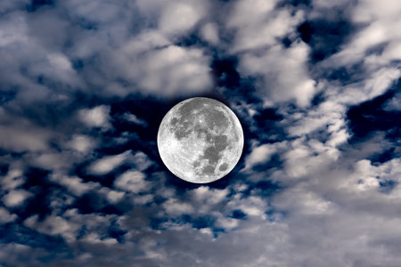 Full moon on the blue sky with clouds.の写真素材