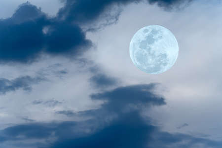 Full moon with blurred clouds on the sky.の写真素材