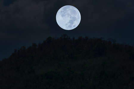 Full moon on the sky over mountain silhouette.の写真素材