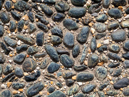 The uneven surface of the cobblestone pavement. Old sidewalk surfaceの写真素材
