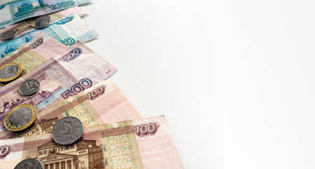 White background with Russian paper rubles and coins. To the right of the money there is room for text.の写真素材