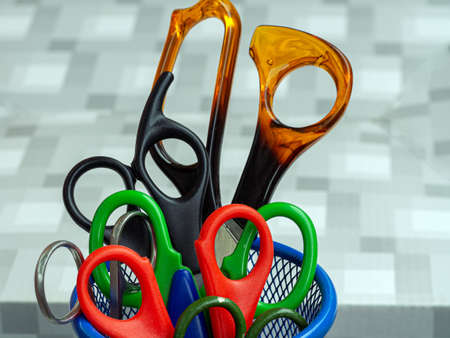 A set of scissors of different sizes in the stand. Scissors for different works, for children and...