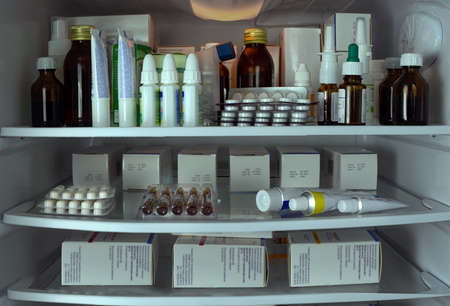 The refrigerator shelves are filled with medicines in packages. Blisters, boxes, tubes, medicine bottles are neatly arranged. Medical education for pharmacies, clinics, hospitals, businessesの写真素材