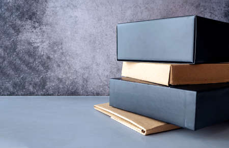 Packaged goods or parcels are stacked on the table. Clean space for text. Delivery by mail, courier service, through the point of issue, online store or warehouse.の写真素材