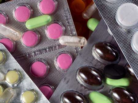 Close-up of drugs in packages and separately. Tablets for various diseases in blisters and in bulk on a medical background for industry, business, pharmacies, clinics.の写真素材
