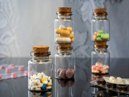 Various medicines are poured into bottles and packaged in blisters. The bottles are on the table and...