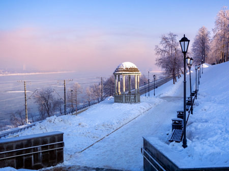 Winter sunny frosty landscape of the Kama River and the city embankment. A pedestrian route leading to the city embankment of the city of Perm past the rotunda. Russia. Winter 2025.の写真素材