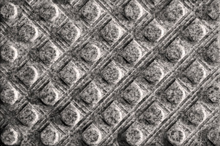 Texture of tactile granite tiles with a grooved surface. Lines of squares, with cylinders in the...