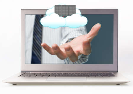 Businessman outstretch hand from Laptop with Palm opening and cloud computing serverの写真素材