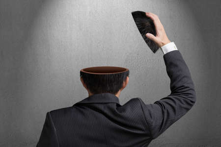 Without any idea inside businessman head in gray concrete wall background