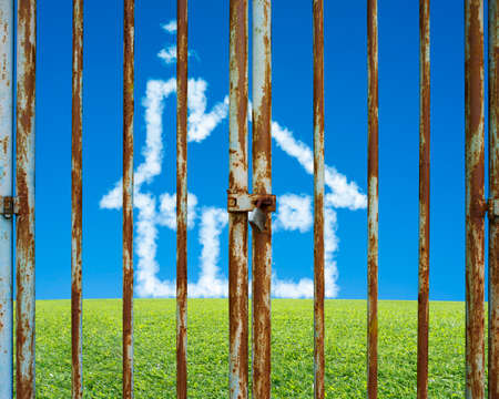 Locked door with cloud house in beautiful landscape green meadow blue sky background