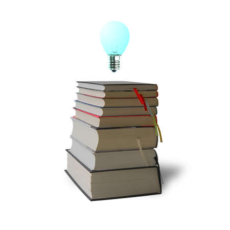 Glowing bulb on top of stack books on white backgroundの写真素材