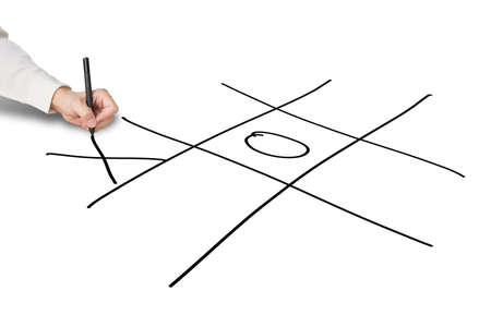 Man hold pen drawing Tic-Tac-Toe game on white backgroundの写真素材
