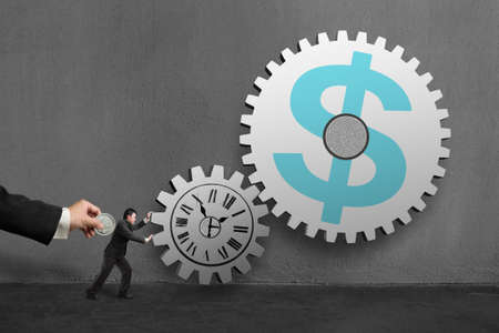 Businessman rolling large concrete gears another hold coin, in concrete wall background.の写真素材