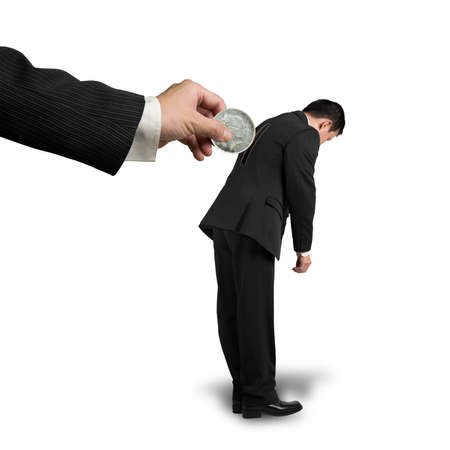 Hand hold money to put into hole on businessman's back, isolated in whiteの写真素材