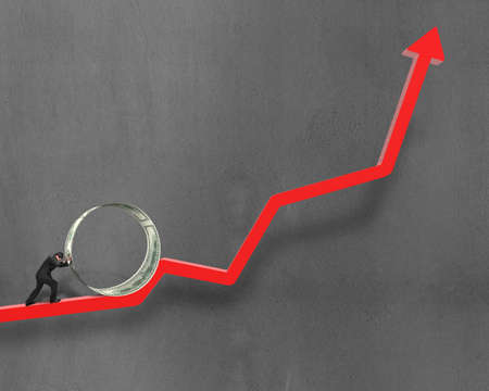 Businessman pushing money circle on growing red arrow with concrete wall background
