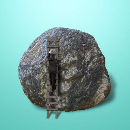 Businessman climbing on wooden ladder to top of rock isolated in greenの写真素材