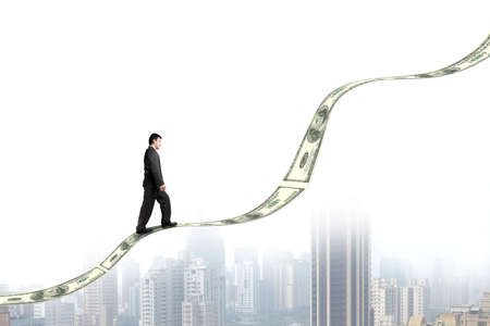 Businessman walking on growing money trend with city view 