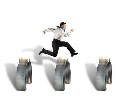businessman jumping over euro symbols isolated in white の写真素材