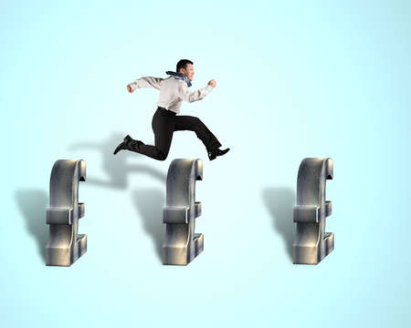 Businessman jumping over pound money symbolの写真素材