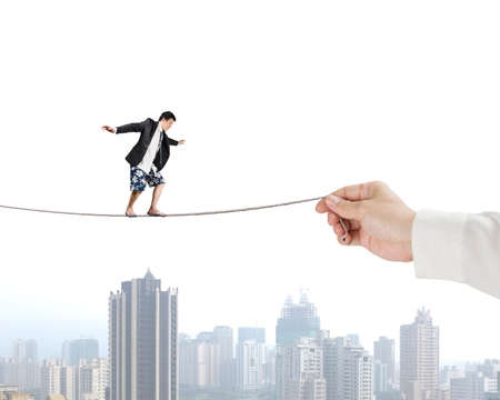 Man balancing on rope with city viewの写真素材