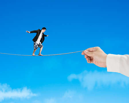 Balancing on rope with blue sky backgroundの写真素材