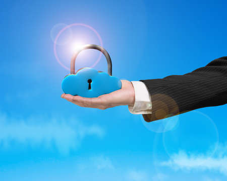 Cloud shape locker on hand with sunlight and blue skyの写真素材