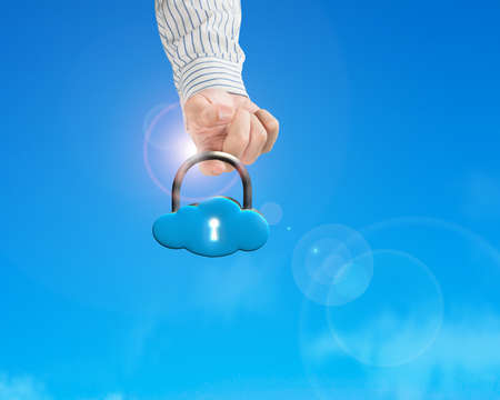 Hand hooking cloud shape lock with sun light blue sky backgroundの写真素材