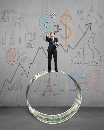 Playing money catch and throw with business doodles on concrete wallの写真素材
