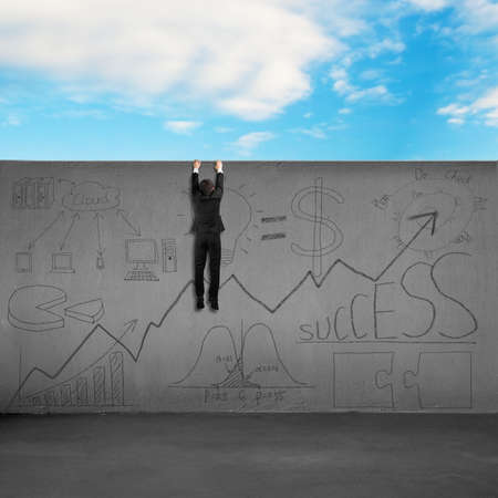 Trying to cross over wall with business doodles blue sky backgroundの写真素材