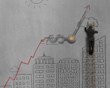 Man drawing cityscape on concrete wall with clock hands and growing arrowの写真素材