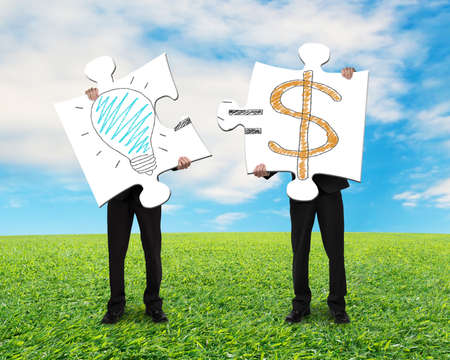 Holding 2 puzzles with idea is money concept on nature 