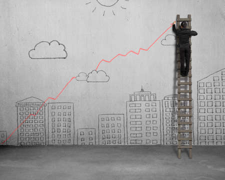 Drawing growing red trend on concrete wallの写真素材