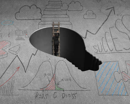 Climbing out from lamp shape hole with wooden laderの写真素材