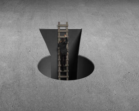 Businessman climbing out from key shape hole on concrete groundの写真素材
