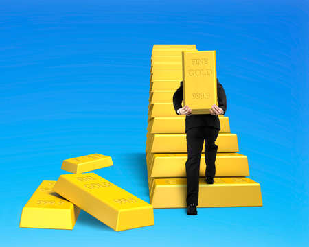 Carrying gold on stairs isolated in blue backgroundの写真素材