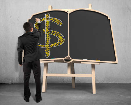 Businessman sketching money symbol on blackboardの写真素材