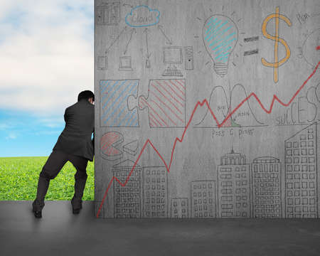 man push away concrete wall with doodles on sky and grass background