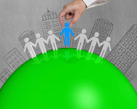 3D male connect on green globe with building doodlesの写真素材