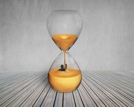 business man flooded in hourglass with concrete wall and wooden floor
