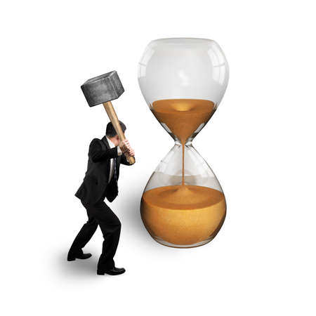 man holding hammer to hit hourglass isolated on whiteの写真素材