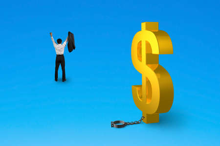 cheering man free from dollar sign shackle isolated on blueの写真素材