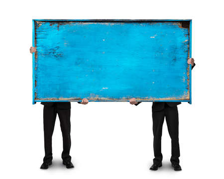 two businessman holding old blue blank wooden billboard isolated on white backgroundの写真素材