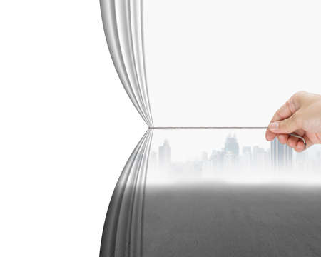 hand pulling gray cityscape curtain revealing empty blank space, isolated on white backgroundの写真素材