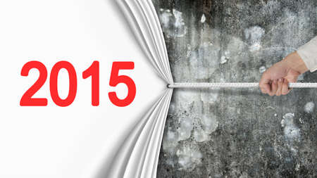 hand pulling 2015 white curtain covering old mottled concrete wall background